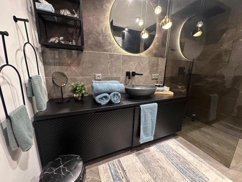 a bathroom with a sink and a mirror at Apartmán Maťko in Levice