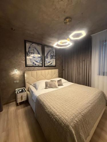 a bedroom with a large bed and two pictures on the wall at Apartmán Maťko in Levice
