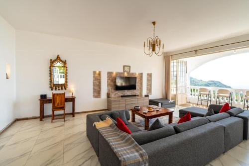 a living room with a couch and a table at White Hill Penthouse in Kisumu