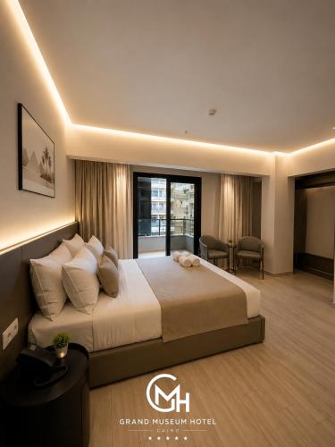 a hotel room with a bed and a desk at Grand Museum Hotel Giza in Cairo