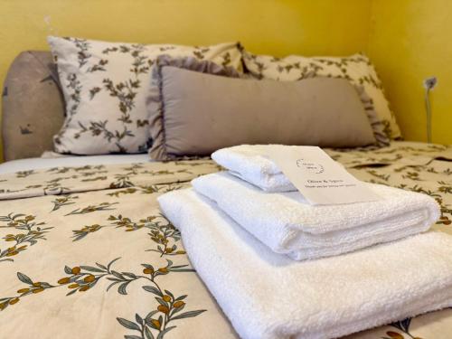 a pile of towels sitting on top of a bed at Apartma Olive & Spice in Koper