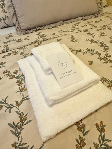 a pile of towels sitting on top of a bed at Apartma Olive & Spice in Koper