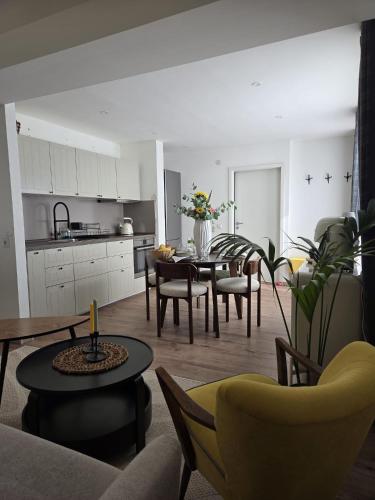 a kitchen and living room with a table and chairs at Calm Sun Apartment in Alpirsbach