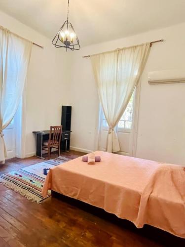 a bedroom with a bed and a desk in a room at Per-en in Cairo