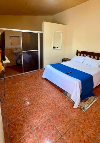 a bedroom with a large bed and a bathroom at Accommodation #7 in Copán Ruinas