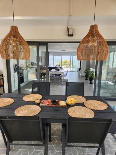 a dining room with a table with food on it at Magnificent view and pool in Albir