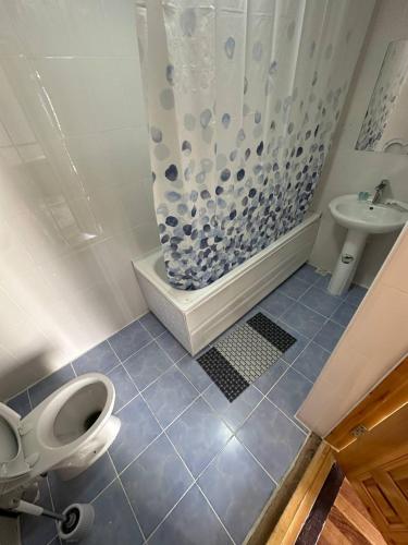 a bathroom with a toilet and a shower and a sink at Merik Boutique in Bukhara