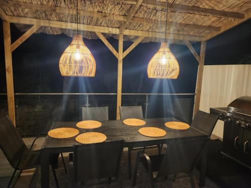 a dining room with a table with chairs and lights at Magnificent view and pool in Albir