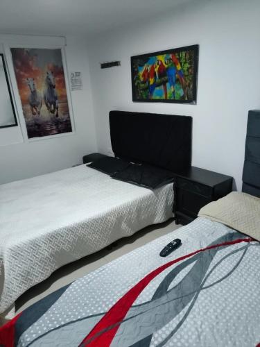a bedroom with a bed and a desk with a laptop at Continental Aparta Hotel Duitama in Duitama