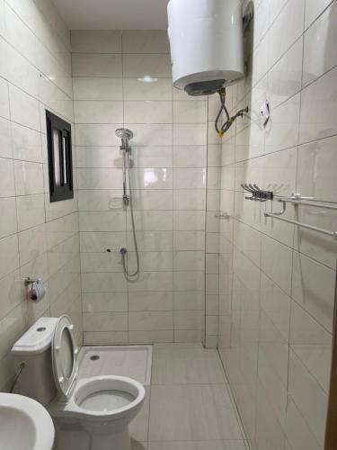 a bathroom with a shower and a toilet and a sink at Résidence MuHamin in Ngaparou