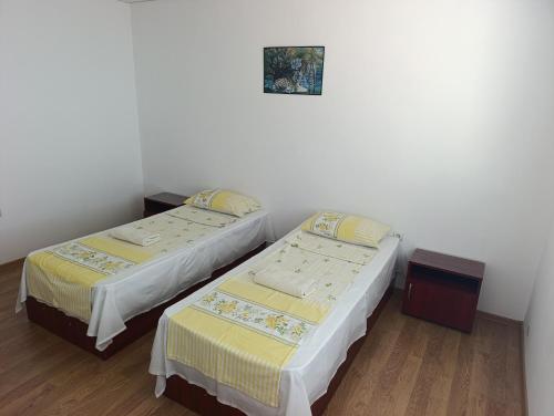 two beds sitting next to each other in a room at Къща за гости ,,Лозница ГТ'' in Varna City