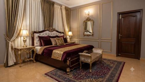 a bedroom with a king sized bed and a chair at P'almshore Ecr' Resort in Mahabalipuram