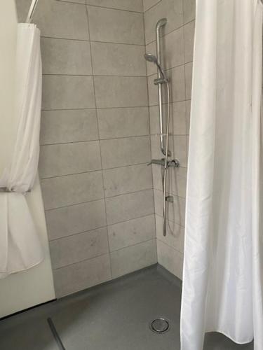 a shower with a shower curtain in a bathroom at 262 Ocean Manor in Blackpool