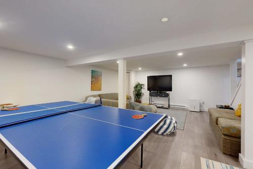 a blue ping pong table in a living room at Sunny Side Up in Oak Bluffs