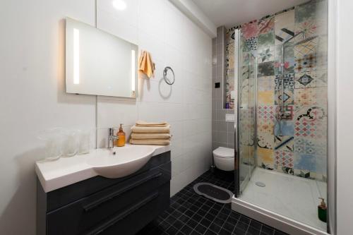 a bathroom with a sink and a shower at Velora apartments in Subotica