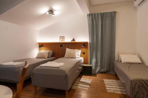 a room with two beds and a window at Velora apartments in Subotica