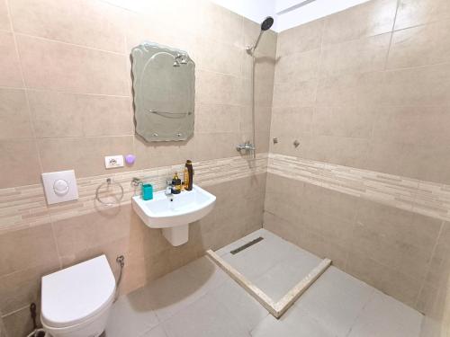 a bathroom with a toilet and a sink at Astir Apartments in Tirana