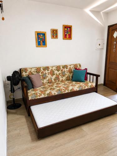 a couch with pillows on it in a room at Recanto Piemont in Serra Negra