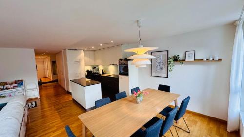 a kitchen and dining room with a table and chairs at Mountainview Apartment - Central - Family - Hiking - Lake and Mountains in Schwyz