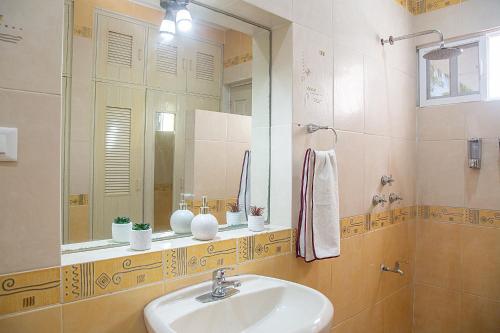 a bathroom with a sink and a mirror at Villas Aura in Mérida