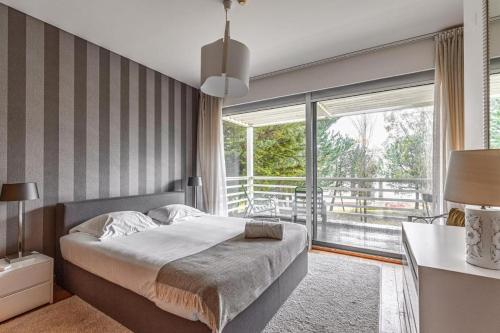 a bedroom with a bed and a large window at Summer Villa in Troia