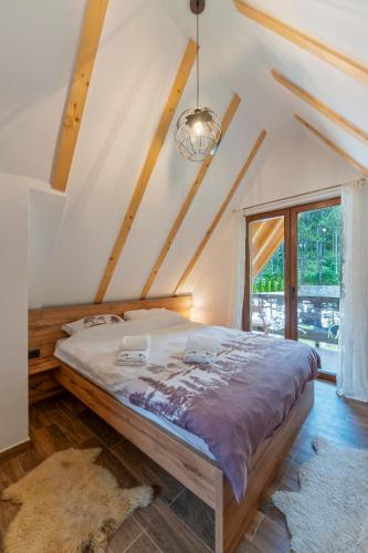 a bedroom with a large bed in a attic at Brvnara Mont in Zlatibor