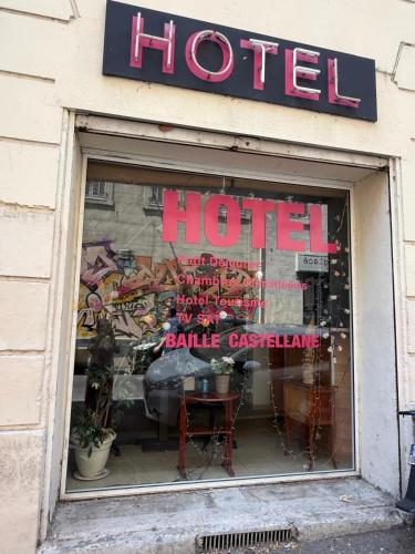 a store window of a hotel with a table in it at Hotel baille castellane in Marseille