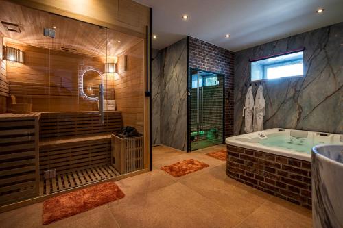 a large bathroom with a tub and a shower at Domaine de Donstiennes in Thuin