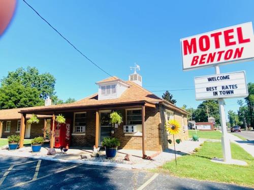 a motel sign in front of a motel room at Benton Motel in Benton