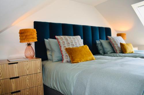 a bedroom with a large bed with a blue headboard at Spacious home in Machrihanish in Machrihanish