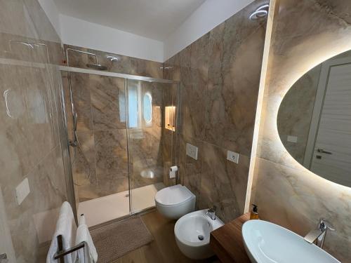 a bathroom with a shower toilet and a sink at Colombo Boutique Rooms in Tortoreto Lido