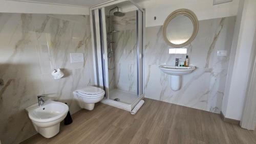 a bathroom with a toilet and a shower and a sink at Casa Vacanze Maurella in Marconia