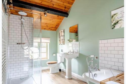 a bathroom with a shower toilet and a sink at The Hurst Stable Sleeps 4 with Hot Tub & Parking in Stafford