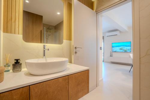 a bathroom with a white sink on a counter at Nautilus Villa - Private Pool II in Elaía
