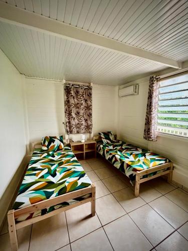 a room with two beds in a room at Kaz alizé in Sainte-Marie