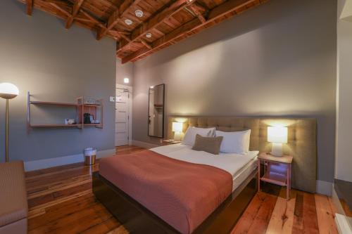 a bedroom with a large bed in a room at Le Pleasant Hôtel in Sutton