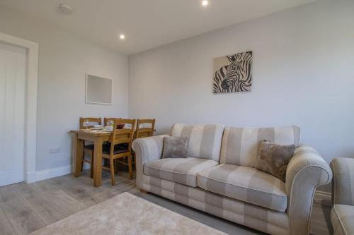 a living room with a couch and a table at Highfield Apartment- 2 Bed in Motherwell close to centre in Motherwell