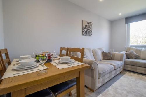 a living room with a table and a couch at Highfield Apartment- 2 Bed in Motherwell close to centre in Motherwell