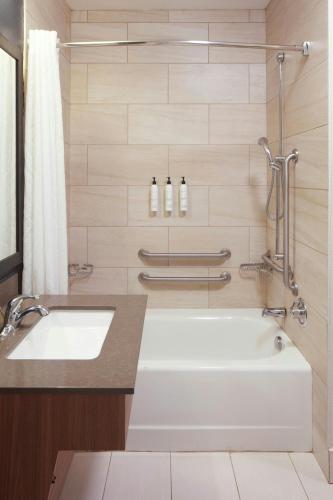 a bathroom with a bath tub and a sink at Fairfield by Marriott Frankfort in Frankfort