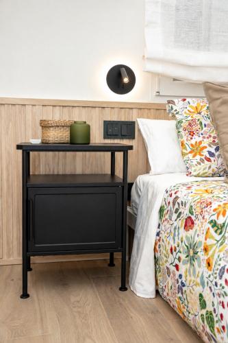 a bedroom with a bed and a nightstand next to a bed at Carvajal Street, Private rooms in Madrid