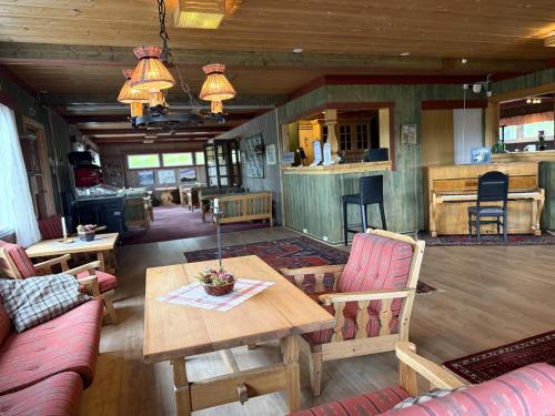 a living room with a table and chairs at Torsetlia in Dagali