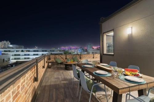 a table and chairs on a balcony at night at Corner Penthouse w Private Balcony Hotel Suite in New Orleans