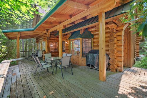 a cabin with a table and chairs on a deck at Creekside Log Cabin - Fireplace - Mt Hood in Mount Hood Village