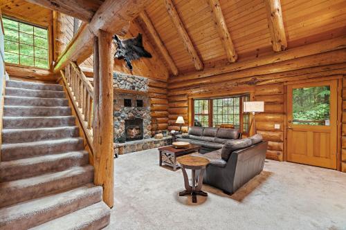 a living room with a couch and a fireplace in a log cabin at Creekside Log Cabin - Fireplace - Mt Hood in Mount Hood Village