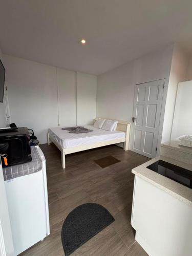a bedroom with a bed and a white door at Colony Stay in Paramaribo