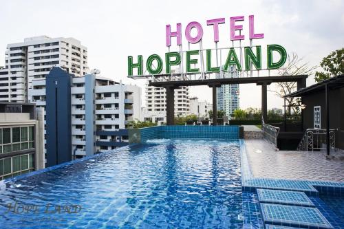 a hotel swimming pool with a sign that reads hotel hogland at Hope Land Hotel Sukhumvit 8 in Bangkok