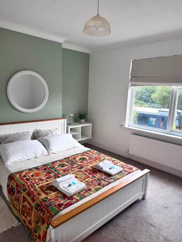 a bedroom with a bed with two towels on it at Central Stay in Southampton