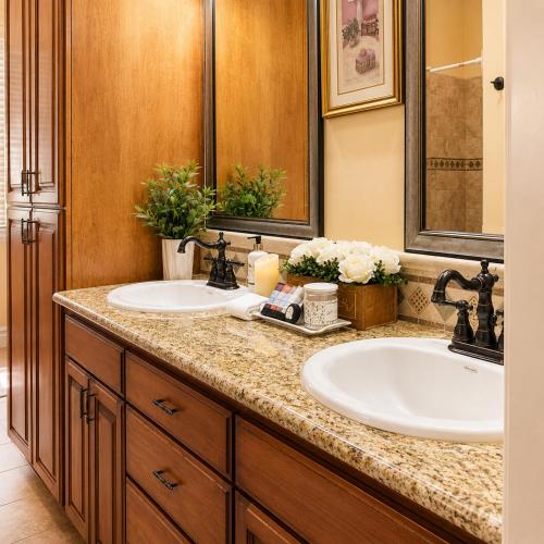 a bathroom with two sinks and two mirrors at Private Master suite with Sauna and Bathtub in Fair Oaks