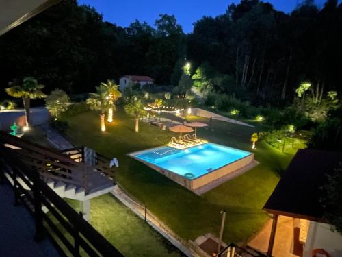 an overhead view of a backyard with a pool at night at Kasa da Caniçada - Gerês in Braga