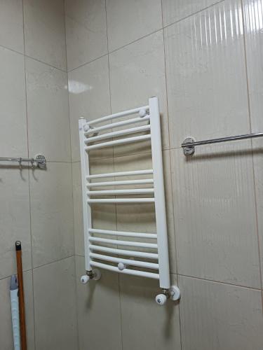 a shower with a white towel rack in a bathroom at Sunny Garden House in Ch'aisubani